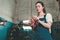 Gender equality. Portrait of a young woman in uniform, working in a workshop, which wipes his hands with a rag. Bottom view. Auto