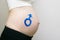Gender male symbol drawn on a pregnant female belly. Pregnant concept. Close-up