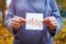 Gender parity concept. closeup caucasian woman shows paper with written text fifty with zeros as male and female gender symbols.