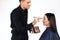 Gender stereotypes. Male make-up artist makes a woman makeup, holding a cosmetic palette on a white background