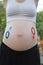 Gender symbols drawn on a pregnant female belly. Pregnant concept. Close-up