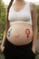 Gender symbols drawn on a pregnant female belly. Pregnant concept. Close-up