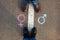 Gender symbols or signs for male and female drawn on asphalt. Male and female legs