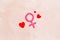 Gender Venus symbol made of contraceptive pills, near heart sign - woman health concept - on beige background top-down
