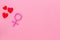 Gender Venus symbol made of contraceptive pills, near heart sign - woman health concept - on pink background top-down
