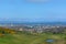 General aerial view from the Holyrood Park to the Edinburgh downtown city, buildings and sea on background