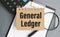 GENERAL LEDGER note is written on a paper