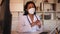 General practitioner woman wearing medical mask talking in office