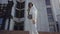 A general slow motion fashion concept with a camera floating of a young dark-haired woman dressed in white clothes for