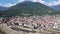 General view of Domodossola city at foot of green Italian Alps in sunny summer day looking out over railway station