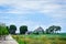 General view of Mont Saint Michel, France. Path, farmland and trees. Blue sky as space for text