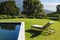 General view of tranquil swimming pool and deckchair with stunning mountains countryside