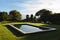 General view of tranquil swimming pool in stunning sunny countryside