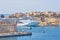 General view of Valletta Grand harbor in Malta with large cruise liner ship in sea bay