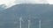 General view of wind turbines in countryside landscape with mountains