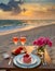 Generated imageSummer love. Romantic sunset dinner on the beach. Table honeymoon set for two with luxurious food