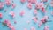 Generative AI Beautiful spring pink flowers on blue pastel table top view Floral border Flat lay style business co