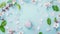 Generative AI Beauty background with facial cosmetic products leaves and cherry blossom on pastel blue desktop bac