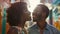 Generative AI Closeup low angle view portrait of a cool african couple laughing talking in a colorful street busin