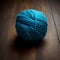 Generative AI illustration of soft blue woolen yarn ball placed on wooden floor