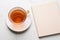 Generative AI Image of Tea Drink in Cup with Blank Book Cover on White Background
