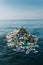 Generative AI. Massive Pile of Plastic Waste Floating in the Ocean Under a Clear Sky. Earth Concept Day