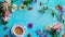 Generative AI Morning cup of coffee and colorful flowers on blue pastel table top view Flat lay style Creative bre