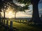 Generative AI. Peaceful Sunset Over a Serene Cemetery by the Water With Lush Greenery. Concept Memorial Day