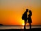 Generative AI. Silhouettes of young people in love at sunset
