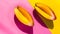 Generative AI Two ripe and juicy mango halves on a hot pink and bright yellow background Contemporary flat lay bus