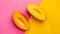 Generative AI Two ripe and juicy mango halves on a hot pink and bright yellow background Contemporary flat lay bus