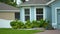 Generic american private house in southwest Florida with big kitchen windows and green lawn on front yard