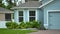 Generic American private house in southwest Florida with roof top covered with asphalt shingles, wide garage door and