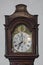 Generic antique old wood and brass grandfather clock face shot straight on that`s no longer manufactured.