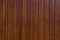 Generic background of a wooden vertical plank wall with screws and nerfs