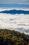 Generic beautiful landscape with mountains ridge rising from the sea of clouds