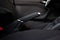 Generic black leather wrapped car hand break lever pulled up front view close up shot