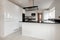 Generic kitchen with gloss white cabinetry and black countertop