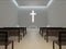 Generic modern church interior 3d rendering, large glowing christian cross.