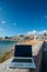 Generic notebook laptop on sunny deserted sandy beach background