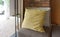 Generic yellow pattern pillow on armchair