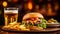 A generous cheeseburger with a pack of fries and a glass of beer. Traditional bar meal.