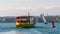 Geneva, Switzerland - April 14, 2019: View of a yellow and red Mouettes Genevoises Navigation boat, a public transport boat