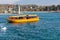 Geneva, Switzerland - April 14, 2019: View of a yellow and red Mouettes Genevoises Navigation boat, a public transport boat