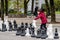 Geneva, Switzerland - April 16, 2019: People playing traditional oversized street chess in Parc des Bastions