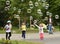 Geneva, Switzerland - June 05, 2017: Children trying to grab soap bubbles on the lakeside Geneva, Switzerland.