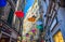 Genoa, Italy, September 11, 2018: colorful multicolored open umbrellas parasols hang among old buildings