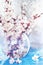 gentle art photo watercolor branches of flowering fruit trees in a transparent vase.