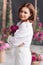 a gentle attractive middle-aged woman in white clothes with a bouquet of peonies