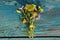 A gentle bouquet of wildflowers. Small flowers on a green wooden background